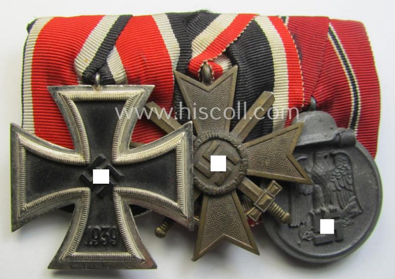 Superb, 3-pieced WWII-period medal-bar (ie. 'Ordenspange') showing respectively an: 'EKII. Kl.', a: 'KvK II.Kl. mit Schwertern' and an: 'Ost'-medal