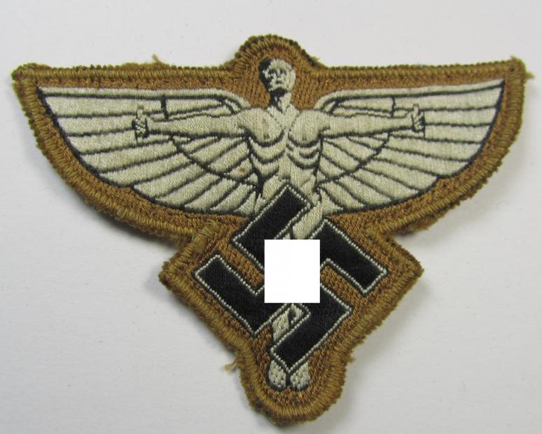 Attractive, tan-coloured, so-called: N.S.F.K.- (or: 'National Socialistisches Flieger Korps') arm-eagle being a nicely woven- (and enlisted-mens'-pattern) example that comes mounted on its piece of tan-coloured wool