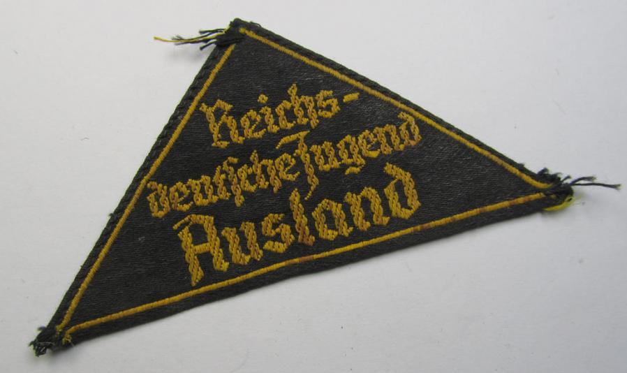 Superb - and extremely rarely encountered! - 'HJ' ('Hitlerjugend') district-triangle (ie. 'Gebietsdreieck') entitled: 'Reichs-deutsche Jugend Ausland' being a truly worn- ie. used specimen that misses its 'RzM'-etiket
