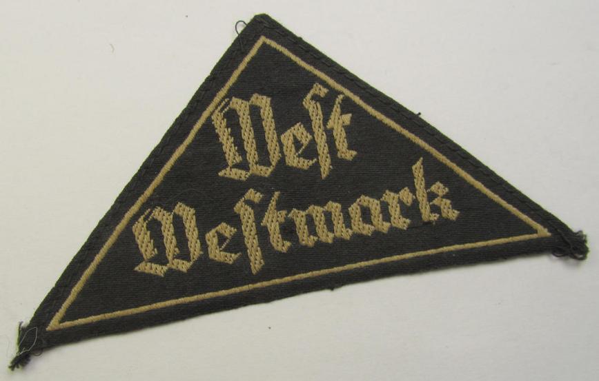 HJ/BDM ('Hitlerjugend' ie.: 'Bund Deutscher Mädel') district-triangle (ie. 'Gebietsdreieck') entitled: 'West Westmark' (being a 'virtually mint- ie. unissued' example that still retains its 'RzM'-etiket)