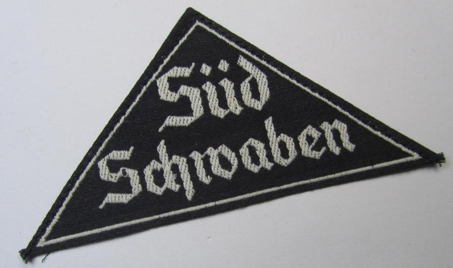 Attractive, 'HJ' ('Hitlerjugend') ie. 'BDM' ('Bund Deutscher Mädel'-) district-triangle (ie. 'Gebietsdreieck') entitled: 'Süd Schwaben' (being a never worn example that still retains its period-attached 'RzM'-etiket)