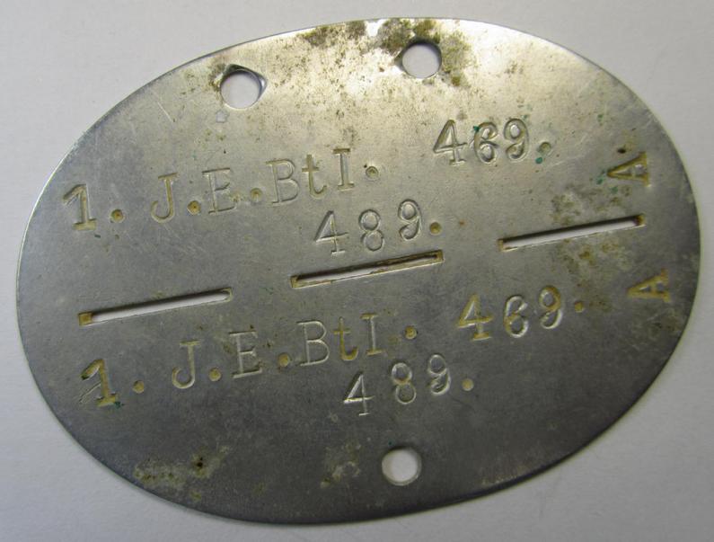 Aluminium-based, WH (Heeres-) ie. 'Infanterie'-related ID-disc bearing the clearly stamped unit-designation: '1.J.E.Btl. 469' and that comes as issued- and/or worn