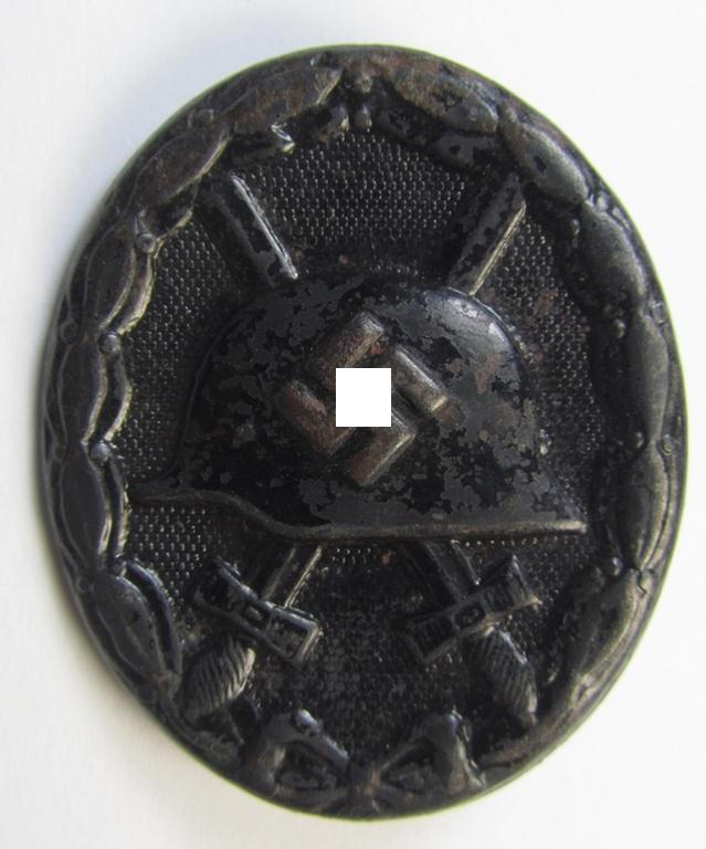 Moderately used- and maker- (ie. '32'-) marked example of a black-class wound-badge (or: 'Verwundeten-Abzeichen in Schwarz') being an example that was produced by the Austrian-based maker (ie. 'Hersteller') named: 'W. Hobacher'