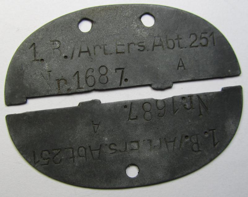 Zinc-based, WH (Heeres) 'Art.-Beobachtungs'- (ie. artillery-observers'-) related ID-disc, bearing the clearly stamped unit-designation that reads: '1. B./Art.Ers.Abt. 251' and that comes as clearly issued- ie. regrettably broken, condition