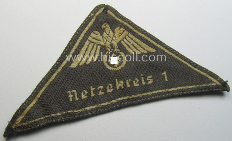 Attractive, German Red Cross (ie. 'Deutsches Rotes Kreuz' or 'DRK') related, EM- (ie. NCO-) type, greyish-coloured- and/or (typically) triangular-shaped arm-eagle as executed in the neat 'BeVo'-weave pattern entitled: 'Netzekreis 1'