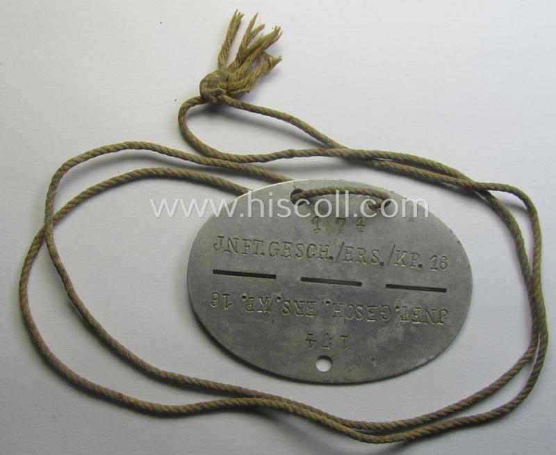 Aluminium-based, WH (Heeres) (ie. 'Infanterie-Geschütz-Ersatz'-related) ID-disc bearing the clearly stamped unit-designation that simply reads: 'Inft.Gesch./Ers./Kp.16' and that comes still mounted onto its (period-attached) cord