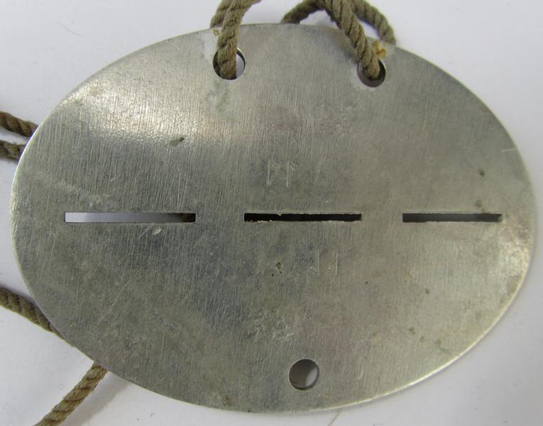 Nice, aluminium-based, WH (Heeres) ID-disc that still comes mounted on its period piece of cord as worn, bearing the engraved ie. stamped unit-designation: 'VIII (Sb)' (IMO: '8. Schützen-Brigade') - overall nice, albeit clearly worn ie. used, condition!
