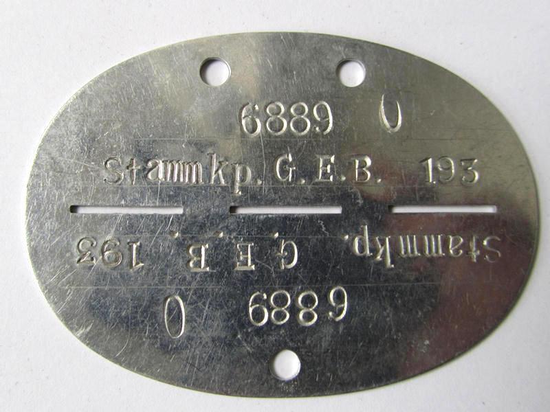 Very nice, aluminium-based, 'Grenadiere' (ie. 'Infanterie'-) related ID-disc, bearing the stamped inscription ie. unit-desigation: 'Stamm.Kp. G.E.B. 193' (or: Stamm-Kompanie des Grenadier-Ersatz-Bataillon 193') - very nice, albeit moderately used ie. worn