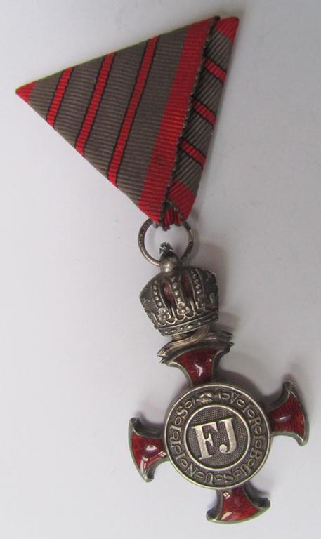 Enamelled, WWI-period-, so-called: 'Habsburger Verdienstkreuz in Silber für Tapferkeit ohne Schwertern 1849 - 1916 (Österreich-Ungarn)' that comes mounted on its original 'Austrian-styled'- ribbon (ie. 'Bandabschnitt')