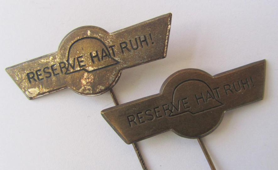 Two-pieced lapel-pin-set comprising of two, tin-based pins (ie. 'Steckabzeichen') both showing the text: 'Reserve hat ruh!', depicting that the bearer was a veteran ie. 'Reservist'