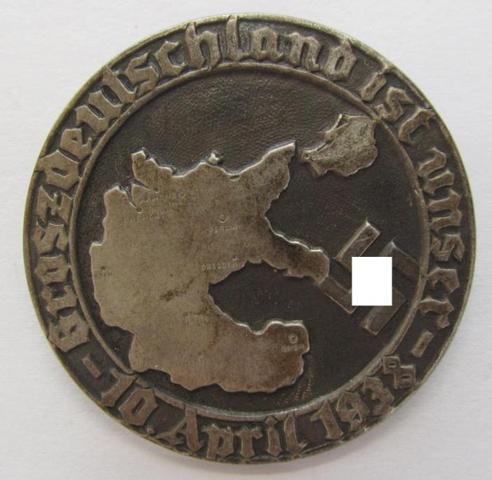 Neat, commemorative - tin-based- and/or silver-coloured - 'tinnie', being a non-maker-marked example, depicting a map of greater Germany and swastika surrounded by the text: 'Groszdeutschland ist unser - 10. April 1938'