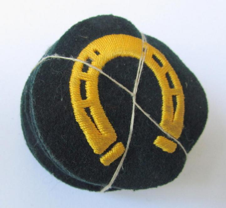 Attractive, WH (Heeres) so-called: trade- and/or special career arm-insignia, as was intended for a: 'Hufbeschlagmeister', being a neatly hand-embroidered variant on darker-green-coloured wool