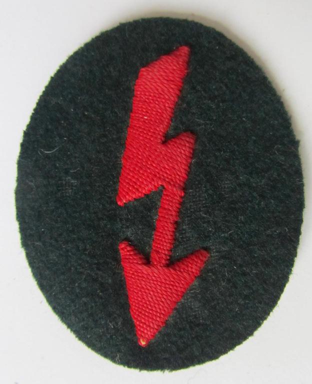 Neat, WH (Heeres) trade- and/or special career-insignia, ie. hand-embroidered signal-blitz, as executed in bright-red, as was intended for a soldier within the: 'Artillerie-Truppen', being a nicely maker-marked example