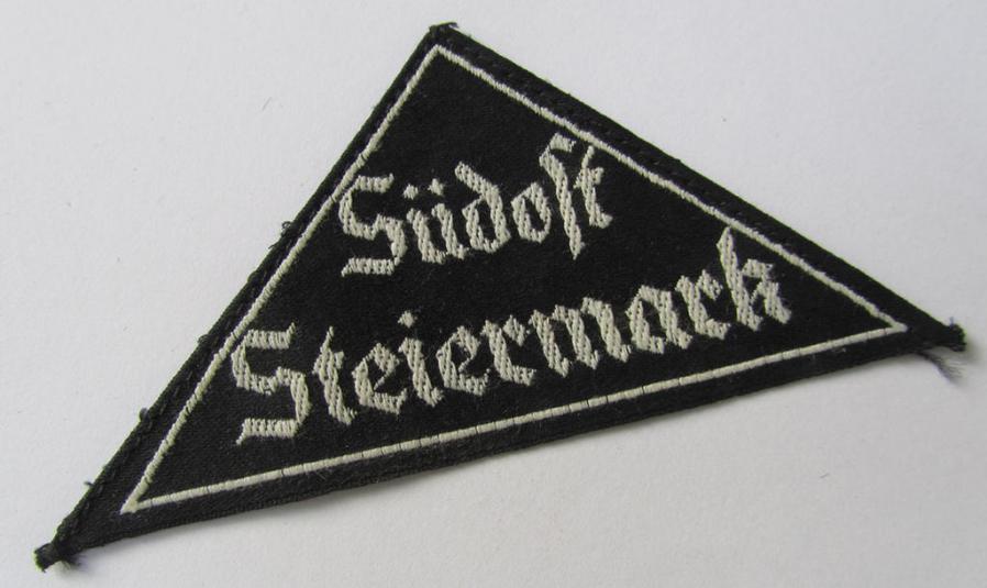 Attractive, 'HJ' ('Hitlerjugend') ie. 'BDM' (or: 'Bund Deutscher Mädel') district-triangle (ie. 'Gebietsdreieck') entitled: 'Südost Steiermark', that comes with its originally attached, paper-based 'RzM'-etiket
