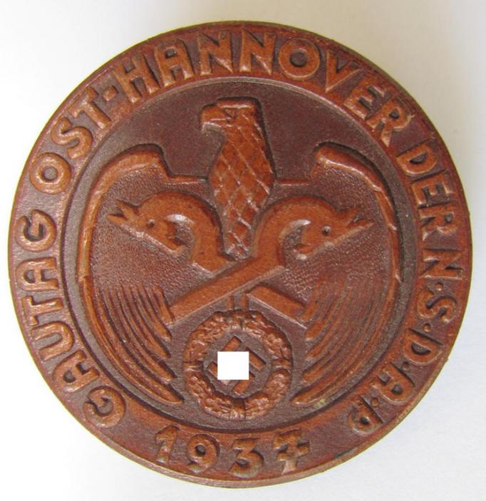 Commemorative - leather-based-, N.S.D.A.P.-related 'tinnie', being a neatly maker- (ie. 'E.O. Friedrich'-) marked example depicting an eagle-sign and two-headed horses-sign surrounded by the text: 'Gautag Ost-Hannover der N.S.D.A.P. 1937'