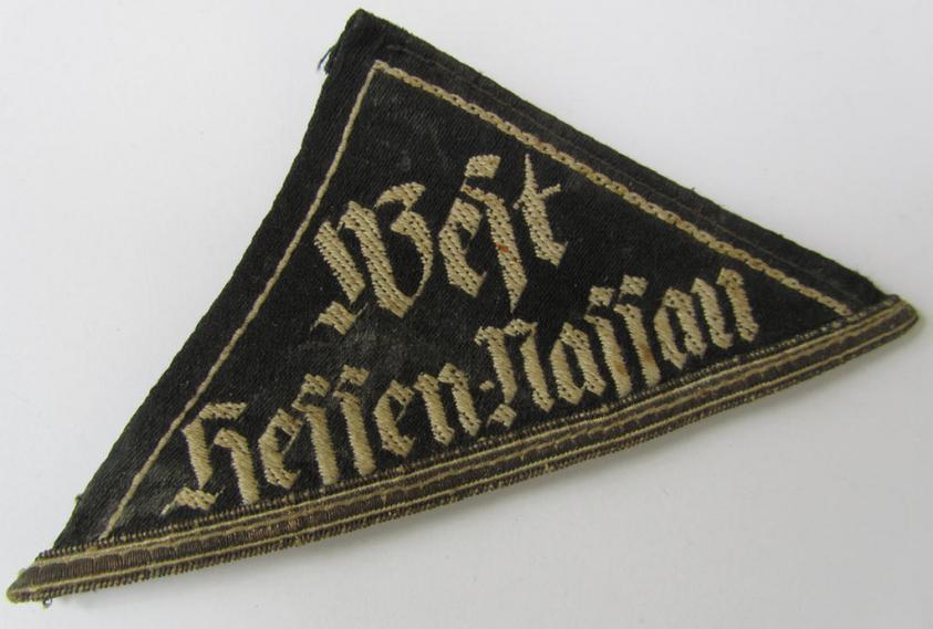 Superb - and actually rarely encountered! - HJ/BDM ('Hitlerjugend'/'Bund Deutscher Mädel') district-triangle entitled: 'West Hessen-Nassau', having a silver-toned 'honorary rank-stripe' attached, signifying BDM-membership before 1933