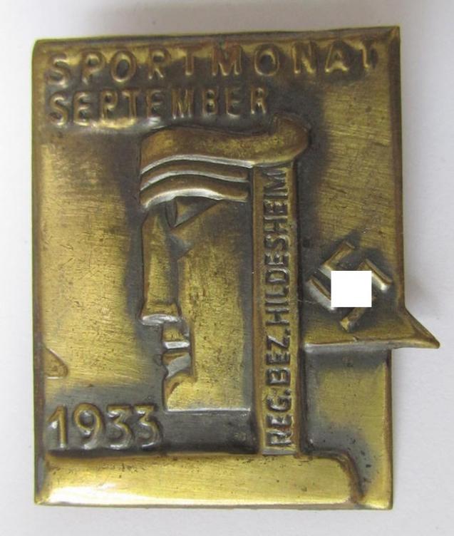 Commemorative- and/or tin-based- 'N.S.D.A.P.'- (ie. sport-) related 'tinnie', being a non-maker-marked example, showing a stylised face and/or swastika-device and the text: 'Sportmonat September - Reg.Bez. Hildesheim 1933'
