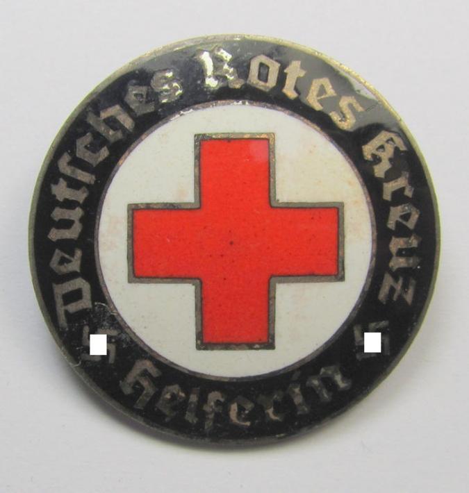DRK (ie. 'Deutsches Rotes Kreuz' or German Red Cross) nurses'-badge, as was intended for a: 'Helferin' (being a non-maker marked example, which is bearing a: 'Ges.Gesch.'-patent-pending marking on its back)
