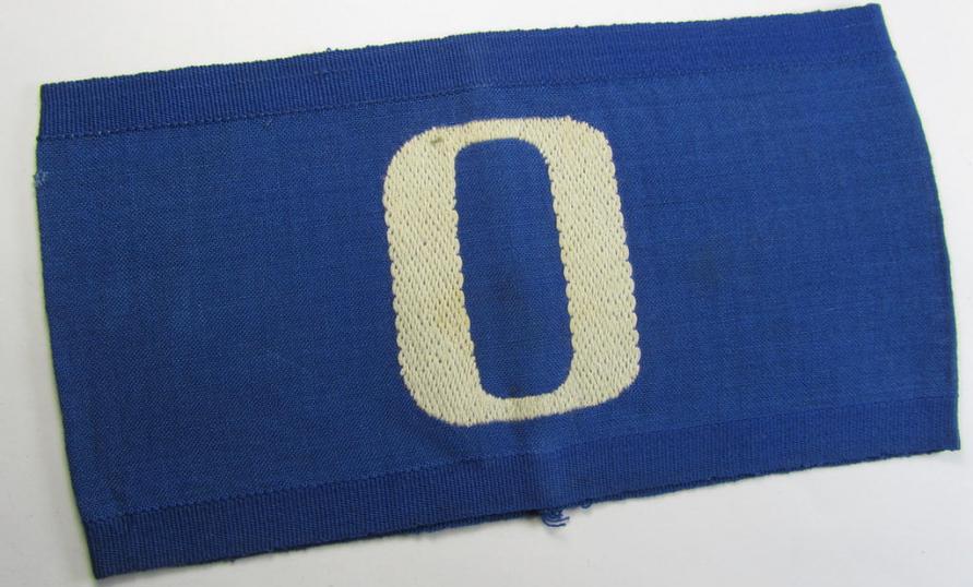 Linnen-based- and/or partly woven-style-, darker-blue-coloured armband (ie. 'Armbinde') depicting a capital 'O'-character, as was presumably intended for staff-members of the German RLB (ie. 'Reichsluftschutz-Bund')