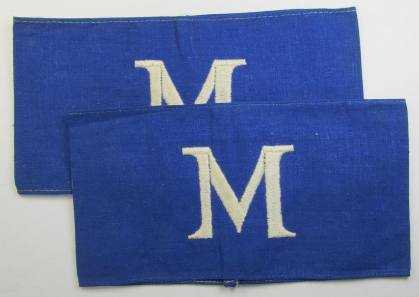 Linnen-based- and/or partly machine-woven-, darker-blue-coloured armband (ie. 'Armbinde') depicting a capital 'M'-character, as was presumably intended for staff-members of the German RLB (ie. 'Reichsluftschutz-Bund')