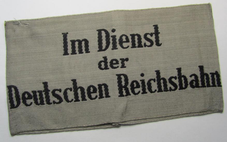 Attractive - and scarcely seen! - example of a DRB- (ie. 'Deutsche Reichsbahn'-) related armband entitled: 'Im Dienst der Deutschen Reichsbahn', being of the 'entirely-woven'-type in a technique similar to the 'BeVo'-weave pattern
