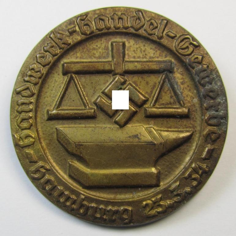 Commemorative, presumably DAF- (ie. 'Deutsches Arbeits Front'-) related 'tinnie' being a non-maker marked example depicting a scale, anvil and swastika and text: 'Handwerk - Handel - Gewerbe - Hamburg - 23.3.34'