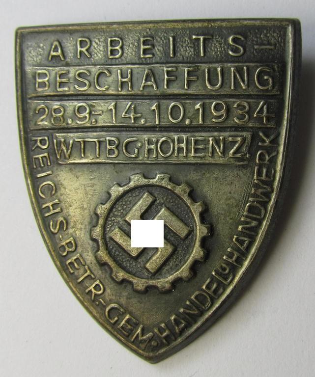 Silver-toned- (and/or tin-based) RAD- (ie. 'Reichsarbeitsdienst'-) related day-badge depicting a so-called: 'RAD-Zahnrad' and text: 'Arbeitsbeschaffung - 28.9.-14.10.1934 - Wttbg. Hohenz.' and sub-titled: 'Reichs-Betr. Gem. - Handel u. Handwerk'