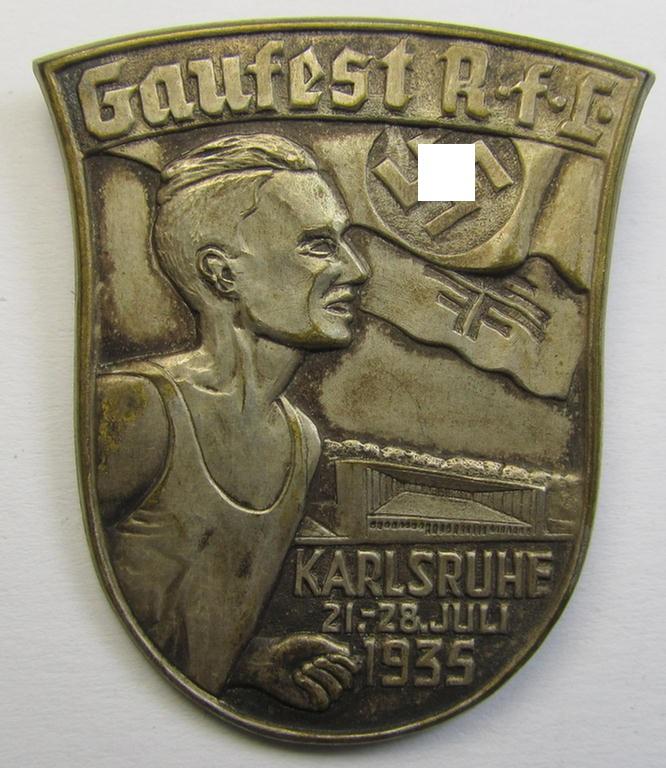 Commemorative - and unusually seen! - tin-based-, silver-toned: 'Reichsbund für Leibesübungen'- (ie. 'N.f.L.') related 'tinnie' showing a sportsman and swastika-device coupled with the text: 'Gaufest R.f.L. -  Karlsruhe - 21.-28.- Juli - 1935'