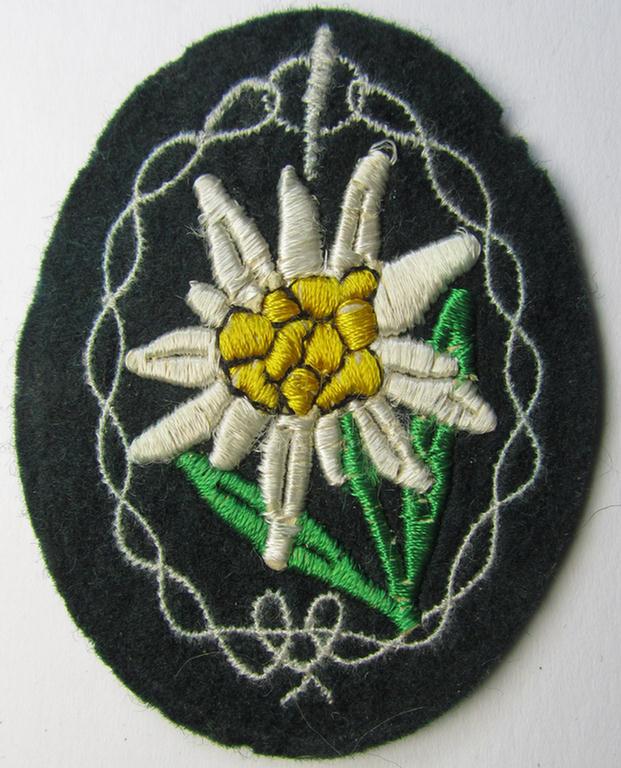 WH (Heeres) enlisted-mens'- (ie. NCO-) type, so-called: 'Edelweiss'-armpatch, being a machine-embroidered example as was executed on darker-green wool, as was intended for usage by the: 'Gebirgsjäger-Truppen' throughout the war