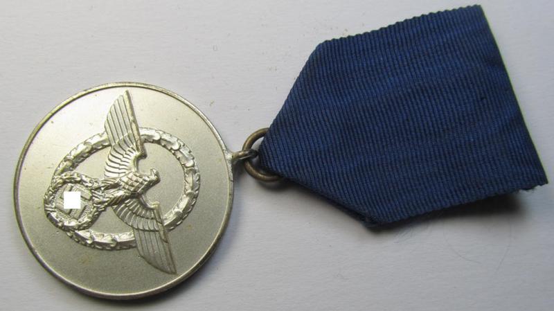 Attractive, bright-silver-toned, so-called: 'Polizei-Dienstauszeichnung 3. Stufe' (or: police loyal-service medal third-class) that comes mounted onto its period ribbon (ie. 'Bandabschnitt')