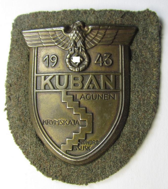 Attractive - and actually scarcely encountered! - WH (Heeres ie. Waffen-SS) 'Kuban'-campaign-shield that comes mounted onto its original field-grey-coloured- and/or woolen-based backing as issued- and/or worn