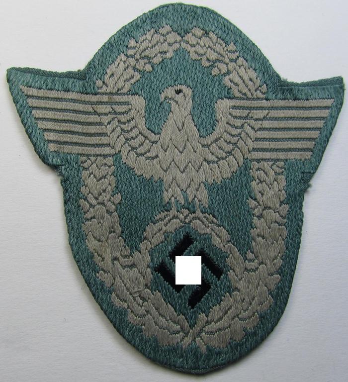 Neat, police- (ie. 'Polizei'-related-) armbadge (ie. arm-eagle) (being a typical 'BeVo'-woven example that comes mounted on a field-grey-coloured background and that comes in a nicely pre-confectioned, condition)
