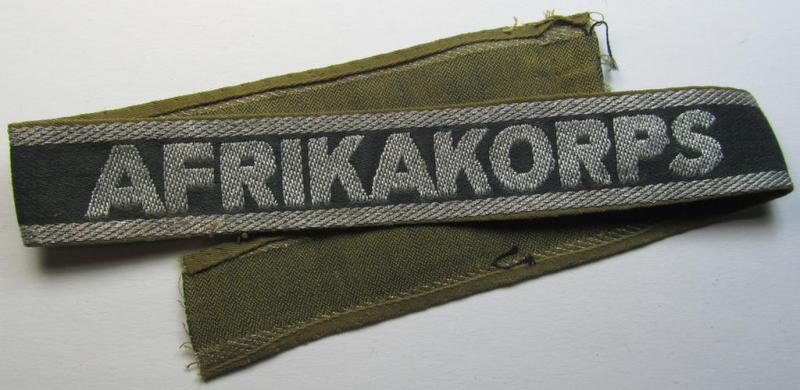 Superb, 'BeVo'-like cuff-title (ie. 'Ärmelstreifen') entitled: 'Afrikakorps' being a with certainty issued and truly worn example that comes in an overall nice- (ie. non-shortened- and most certainly once tunic-attached-), condition