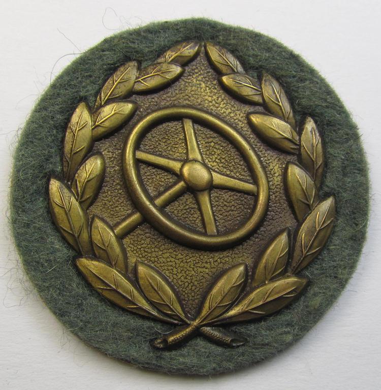 WH (Heeres- ie. Waffen-SS) so-called: 'Kraftfahrbewährungs-Abzeichen in Bronze' (or: drivers' proficiency-badge in bronze) that comes mounted onto its piece of field-grey-coloured wool as most certainly issued- albeit simply never worn, condition