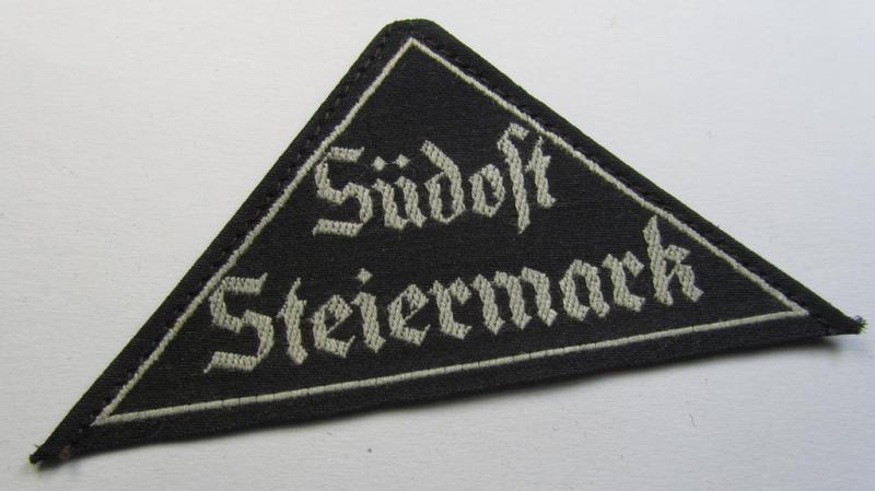 Attractive, 'HJ' ('Hitlerjugend') ie. 'BDM' ('Bund Deutscher Mädel'-) district-triangle (ie. 'Gebietsdreieck') entitled: 'Südost Steiermark' (being a 'virtually mint- ie. unissued' example that still retains its paper-based 'RzM'-etiket)