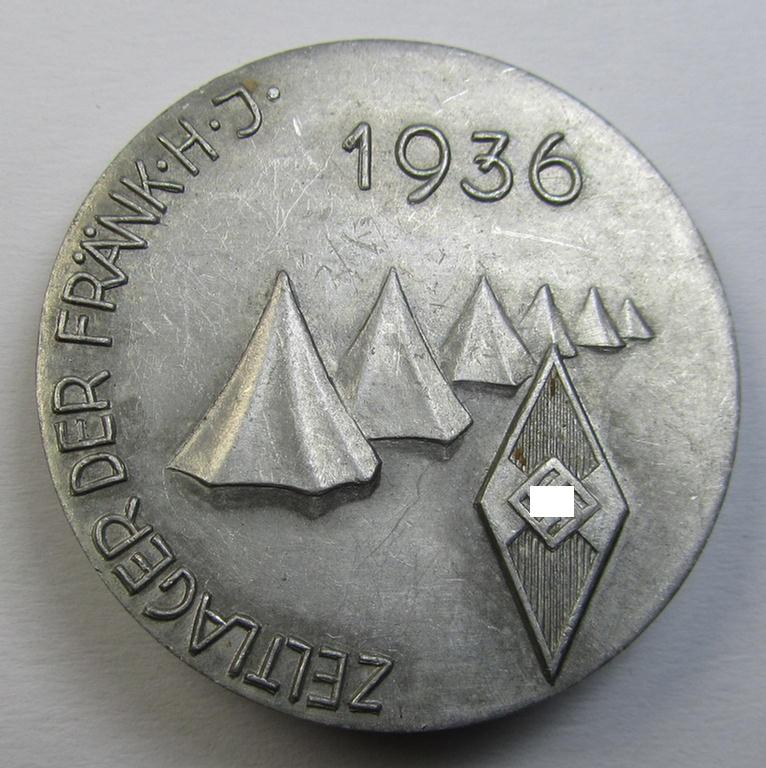 Commemorative - aluminium-based- and/or: typical greyish-silver-coloured - 'HJ'- (ie. 'Hitlerjugend'-) related 'tinnie' being a non-maker-marked example depicting a: 'HJ-Raute' surrounded by the text: 'Zeltlager der Frank. H.J. - 1936'