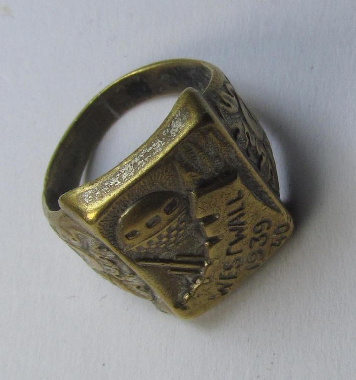 Attractive, pre-war-period- (and Third-Reich-related) metal-based (ie. bright-golden-coloured- and I deem copper-based-) 'souvenir'-ring depicting an engraved outline of a: 'Westwall'-fortification and showing the engraved text: 'Westwall 1939-40'