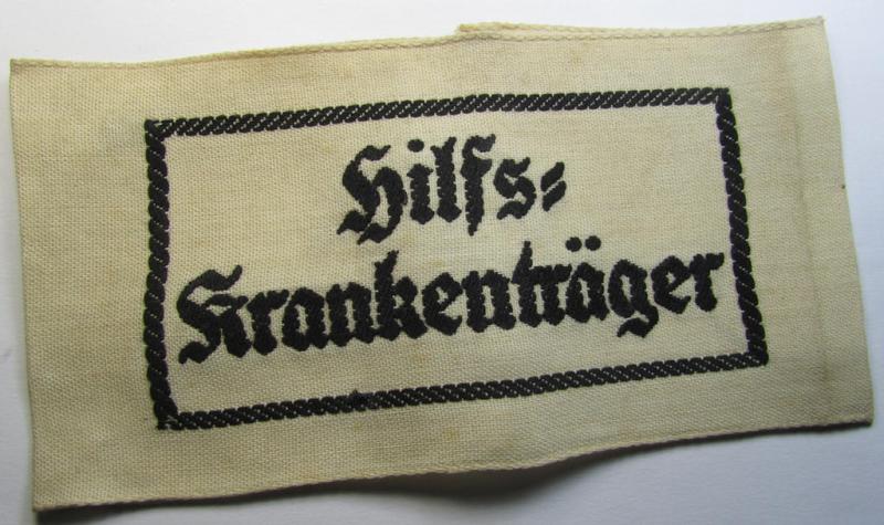 Neat, beige/white-coloured- and/or linnen-based armband (ie. 'Armbinde') as was executed in the 'thicker-styled' fabric as was intended for WH (Heeres) staff-members working as: 'Hilfs-Krankenträger'