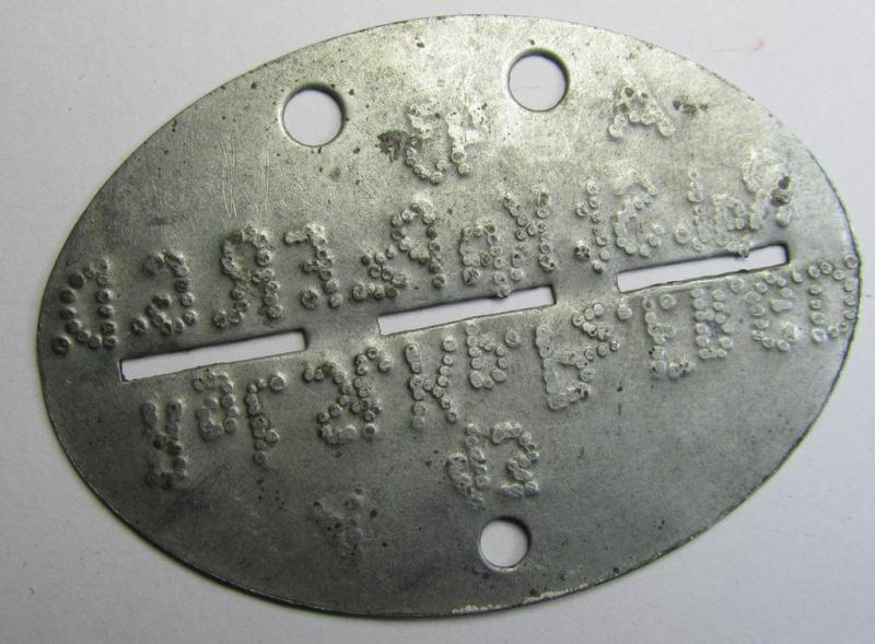 Attractive - and very ususal! - typical steel-based WH (Heeres) 'GrossDeutschland-Division'-related ID-disc bearing the (somewhat roughly- and privately done!) stamped unit-designation that reads: 'Rgt.St.Kp.Pz.F.R.G.D.'