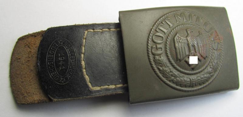 Attractive, WH (Heeres) field-grey-coloured- and/or steel-based belt-buckle being a neatly maker- (ie. 'Noelle & Hueck'-) marked- and/or: '1941'-dated example that comes mounted onto its (black-coloured) leather-based tab