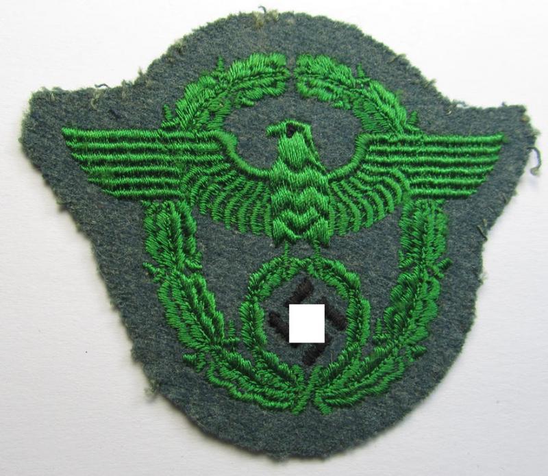 Police- (ie. 'Polizei'- ie. 'Gendarmerie'-) related machine-embroidered-pattern arm-eagle, as executed in bright-green-coloured linnen on a typical 'Polizei'-coloured- and/or woolen-based, background