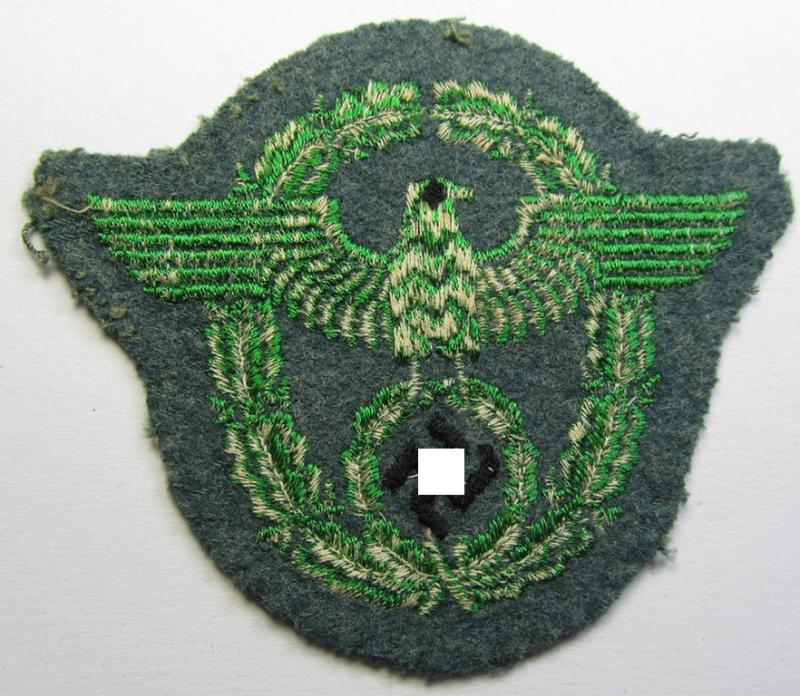 Police- (ie. 'Polizei'- ie. 'Gendarmerie'-) related machine-embroidered-pattern arm-eagle, as executed in bright-green-coloured linnen on a typical 'Polizei'-coloured- and/or woolen-based, background
