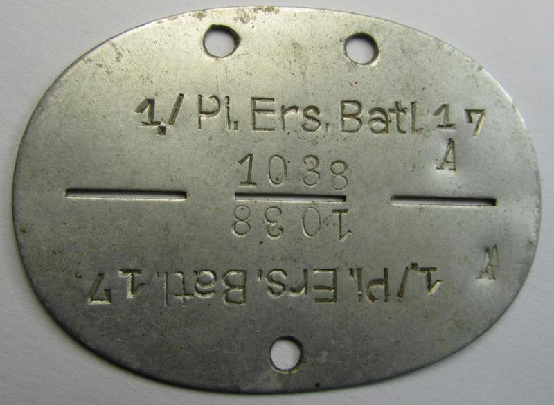 Attractive, aluminium-based, WH (Heeres) ie. 'Pioniere'-related ID-disc bearing the clearly stamped unit-designation: '1./Pi.Ers.Batl.17' and that comes stored into its (period) leather-based pouch as worn