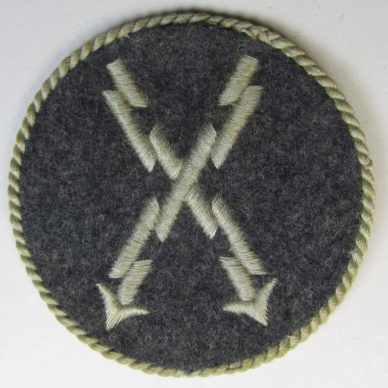 Attractive - albeit clearly used! - example of a WH (Luftwaffe) machine-embroidered, trade- ie. special-career-patch (ie. 'Tätigkeitsabzeichen') having a silverish-grey-toned 'Kordel' attached as was intended for: 'LW-Fernschreib-Unteroffiziere'