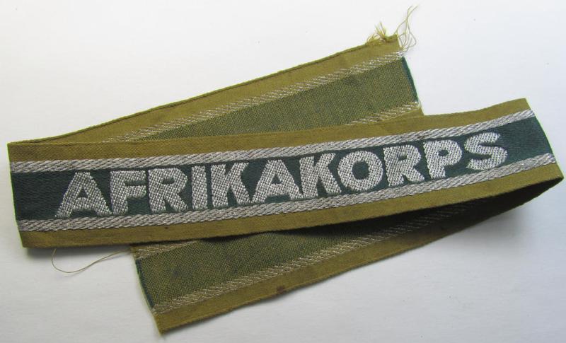 Superb, 'BeVo'-like cuff-title (ie. 'Ärmelstreifen') entitled: 'Afrikakorps' being a with certainty issued and truly worn example that comes in an overall nice- (ie. non-shortened- and most certainly once tunic-attached-), condition