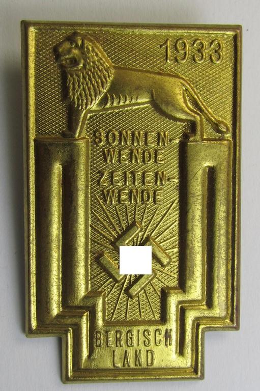 Commemorative, tin-based- and/or: golden-coloured, early-period N.S.D.A.P.-related 'tinnie' being a non-maker marked example depicting a lion and 'swastika'-sunburst-device and bearing the text: 'Sonnenwende Zeitenwende - Bergischland - 1933'