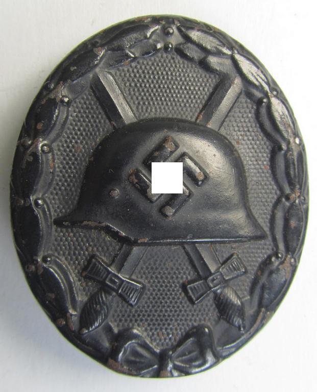 Moderately used and neatly maker- (ie. '88'-) marked example of a black-class wound-badge (or: 'Verwundeten-Abzeichen in Schwarz') being an example that was produced by the desirable maker (ie. 'Hersteller') named: 'Werner Redo'