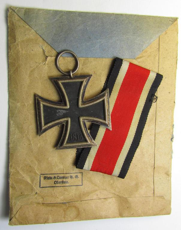 'Eisernes Kreuz 2. Kl.' (ie. Iron Cross 2nd Class) being a maker- (ie. '65'-) marked example that comes stored in its period (albeit sun-faded!), 'Zellstoff'-based pouch as was produced by the: 'Klein & Quenzer'-company