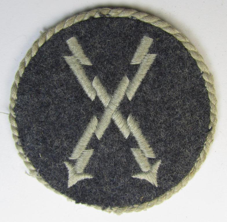 Attractive - albeit clearly used! - example of a WH (Luftwaffe) machine-embroidered, trade- ie. special-career-patch (ie. 'Tätigkeitsabzeichen') having a silverish-grey-toned 'Kordel' attached as was intended for: 'LW-Fernschreib-Unteroffiziere'