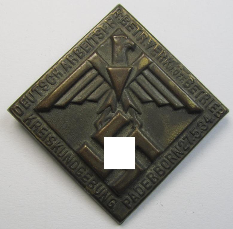 Golden-bronze-toned, (I deem) N.S.D.A.P.-related- (and fairly early-period!) day-badge (ie. 'tinnie') as was issued to commemorate a gathering entitled: 'Kreisführerschule Hans Huebenett - Brieg - 23. Juni 1934'